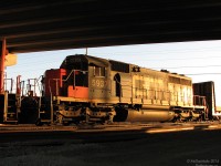 One of the last two SD40-2's in Grand Trunk Western blue paint (most were repainted CN or disposed of), GTW 5937, glows in the setting sun under the Bramalea Road bridge. Trailing a CN SD75i on X392, they're awaiting the signal at Halwest before proceeding east. <br><br> This one took some waiting for, as its arrival was delayed a number of hours by a power swap between an ailing westbound and this extra run of 392. The whole 2+ hour Georgetown GO rush passed by before X392 made an appearance. Luckily, they gave another one of their units away to the other train and kept 5937, which (also luckily) ended up stopped here for a better photo. Normally stopping under a bridge would be a bad thing for lighting, but at this point the sun had gone down so far that it crept underneath and lit the unit up. Go figure.