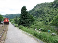 <p>The Agawa Canyon Tour Train, with CN GP9Rm 4110 on the south end, rests at Agawa Canyon Park while the passengers enjoy the scenery at the remote wilderness location of the park. All too soon it's time to head south again.

<p>The small car parked on the house track to the left of the train is the railway's "camp car", which can be rented out for overnight stays, like an RV on rails.