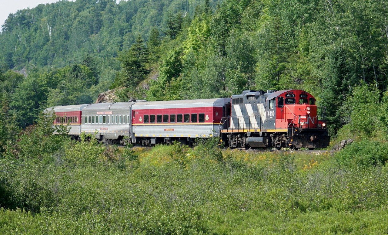 The southbound Agawa Canyon Tour Train, with CN GP9Rm 4110 on the southbound head end, approaches mile 10 just north of the former location of Odena siding on the former Algoma Central Railway.