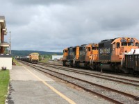 Northbound train 113 from North Bay arrives in Englehart behind SD75i 2102 and SD40-2s 1730 and 1734, while its southbound counterpart no. 214 waits to depart for North Bay with SD75i 2105 and SD40-2 1735.