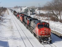 Back before CN 421 became an early morning trip through St. Catharines, it would often come it the late morning and early afternoon. Here it passes just before 1pm with a four unit lashup, the last being a GP9rm in transit most likely to Port Robinson. The tad bit of extra horsepower probably helped though, as this train is a good 150 cars in length. 