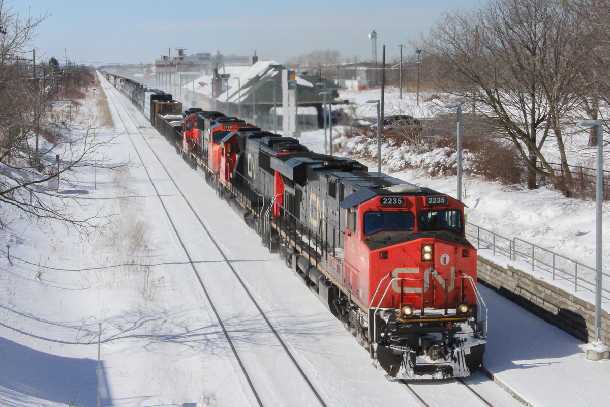 Back before CN 421 became an early morning trip through St. Catharines, it would often come it the late morning and early afternoon. Here it passes just before 1pm with a four unit lashup, the last being a GP9rm in transit most likely to Port Robinson. The tad bit of extra horsepower probably helped though, as this train is a good 150 cars in length.
