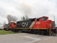  CN GP38-2w 4785 and GMD1 1444 at home in there city of manufacture. Seen here at Wilton Grove side road in the south end of London on the former London and Port Stanley railway track age. Having just completed switching the Casco plant the engineer cracks the throttle to clear the crossing of heavily backed up traffic.