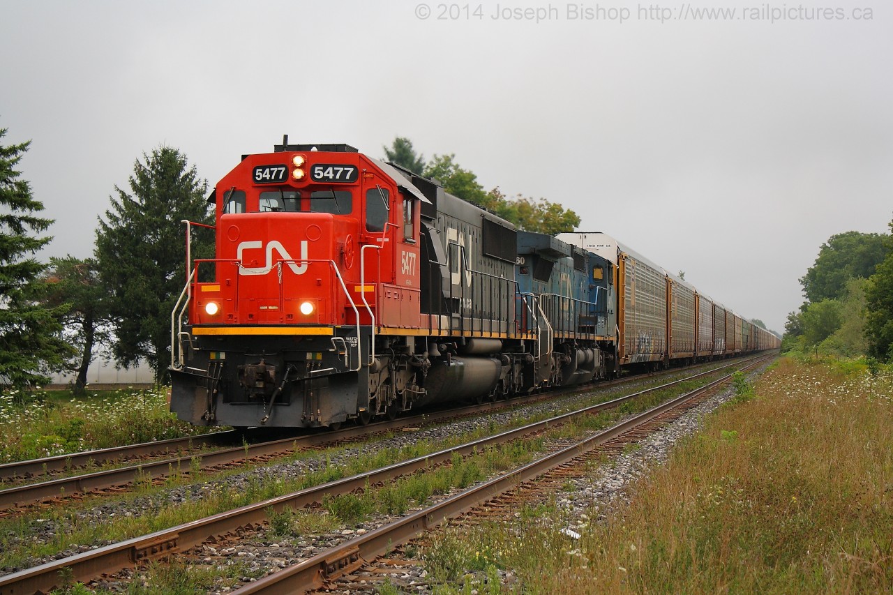 CN 393 crawls towards the crossing in Lynden with CN 5477 and IC 2460 providing the horsepower.