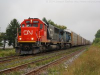 CN 393 crawls towards the crossing in Lynden with CN 5477 and IC 2460 providing the horsepower.  

