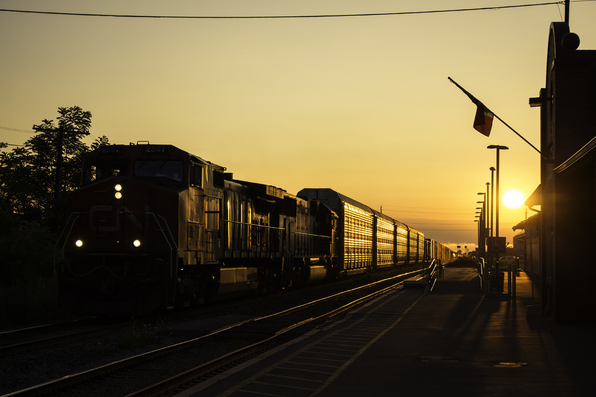 Rarely am I ever happy with the lighting that is displayed around any train that passes through Niagara, however I can't complain about this. With evenings shortening everyday, and a CN 330 that shows up well later than usual, the sun ended up just above the roof of the station as it passed by with CN 2597 and IC "Deathstar" 1036. Looking a little more like CN 421, this train had autoracks and autoparts cars, the autoparts of which are especially a rarity. Nipping at 330's heels was GO 781, which was 14 minutes late. If it had been on time, 330 likely would have held back at Nelles Road, and this decent lighting would have ceased to exist. Then again, I'd just be capturing a GO train with the sun in the background, however I take the freight. The sun makes the adjacent track look like it was part of a branch line, but indeed this particularly section is good for 60mph for freight, 65mph for passenger.