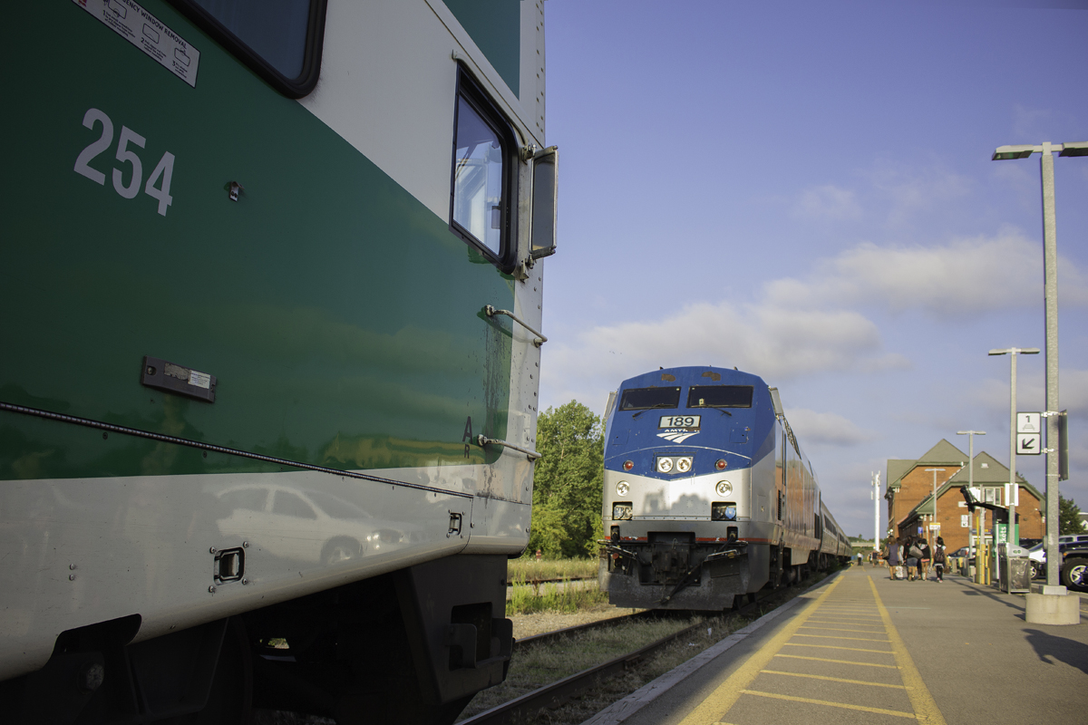 The Big Game is on!  Amtrak 189, the "Big Game Unit" squares off with GO cabcar 254 in this battle for territory at Niagara Falls station. While GO 787/788 has had this problem with Amtrak all summer, the faces have gotten closer because GO is now running 12 car trips to Niagara Falls because of the CNE, and the entire GO train wouldn't even fit on the platform. 10 minutes of spotting to know what doors couldn't be opened discovered that only 10 cars were on the platform. With each train not even 20 feet apart, the shadows of the GO cabcar bell and horn are shown on the nose of the Amtrak unit. In the end, the "Big Game Unit" won the battle as it had arrived well before the GO did, and was nearly done customs. The GO backed out out, and proceeded onto the far track, before coming back into the station. Considering this is Rule 105, or "Dark Territory", the RTC was not involved, and efficiently handled only by the two train crews.