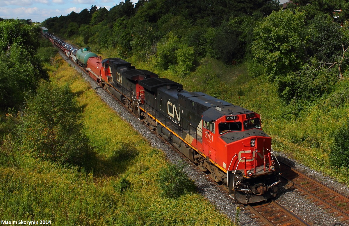 While waiting for the legendary CN U710 with the Burlington Northern Santa Fe leader, CN 303 roars by in almost perfect light.