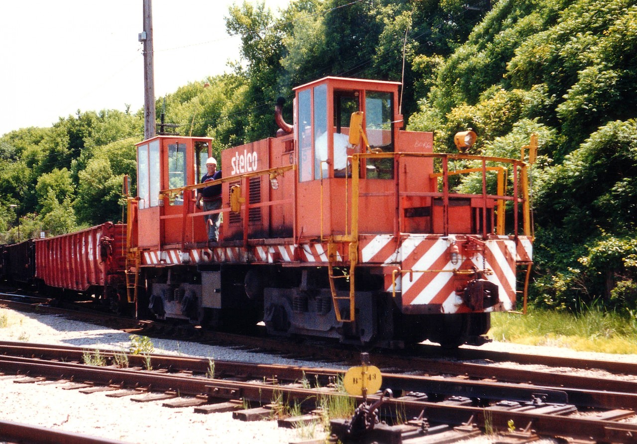 Here is an odd duck. According to whom I am told is a reliable source, this relic was initially built way back in 1906 by National Steel Car for Ontario Hydro as a 600v locomotive. It was sold to Stelco in 1926. Was rebuilt by them into a gas/electric. In 1953 the superstructure was stripped down and a CAT prime mover was installed, and control stand now on open deck. The ROD mill had two of these, 6335 and 6336. This unit pictured, 6335,  was scrapped in 1999. One would think this could be the oldest locomotive featured on RP.ca thus far ??? Perhaps someone (other than the informant) who worked/retired from Stelco could shed more light on this rather unusual beast.