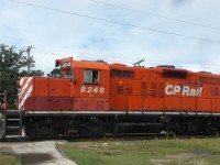 CP 8248 (GP9u) and CP 8200 (GP9u) cross Taylor Ave, with a short train, on the CP La Riviere Sub.