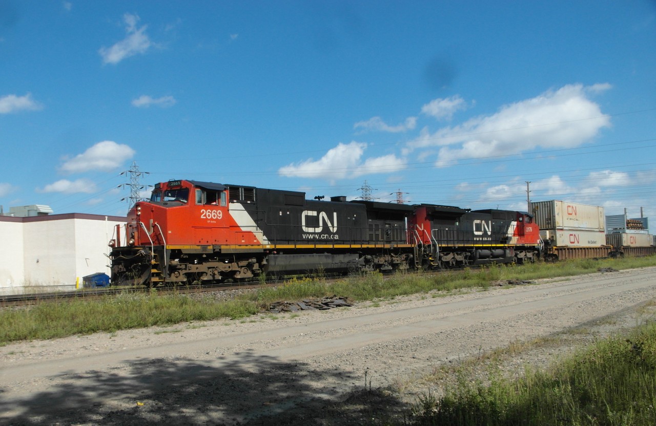 CN 2669 and CN 2179 pull an intermodal train west on the CN Rivers Sub.