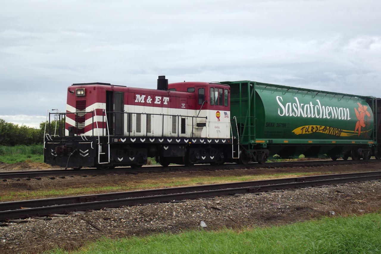 64 year old GE 70 Tonner, former Modesto and Empire Traction Co 604, shows no sign of slowing down in Chamberlain, SK. Built in Jan, 1950, and retired by M and ET in 2009, she replaced the Trackmobile that had been stationed here since the transload operation began. 604, and 3 sister units arrived on the LMRR in 2012 and sat for a year before being assigned work. 604 is pulling a string of empties back under the loading chute after pushing 3 loads onto the main for pick up by MGLX 3138.