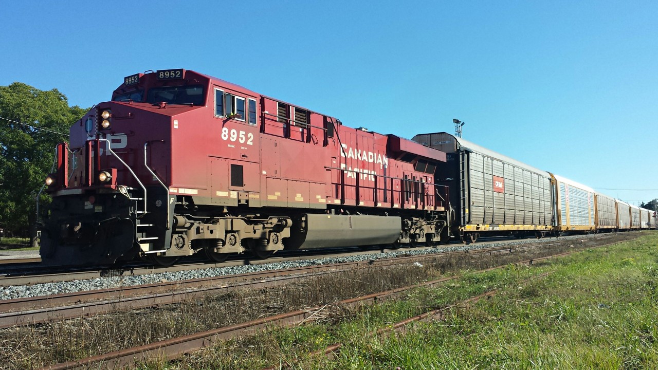 After stopping and uncoupling from his train to inspect the yard for work, CP 8952 has recoupled to his train and, with a friendly wave from the conductor, is accelerating eastward. Thanks dad for bringing me out.