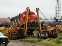 After being set off by 435 the previous day, we see CN 4713 receiving a new traction motor with some help from a pair of Hulcher's Caterpillar 583H side boom's