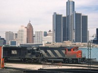 CN GP40-2LW 9511 and N&W SD40-2 6195 rest by the Windsor roundhouse & turntable at CN's old engine terminal, once located along the Detroit River waterfront. Across the border, the skyline of the City of Detroit looms in the background. Today the rails are gone from the Windsor waterfront, along with the roundhouse and turntable. 9511 was retired by CN in the mid-late 90's and now hauls commuter trains for the MBTA. N&W 6195 works for the Norfolk Southern (after the N&W-Southern merger).