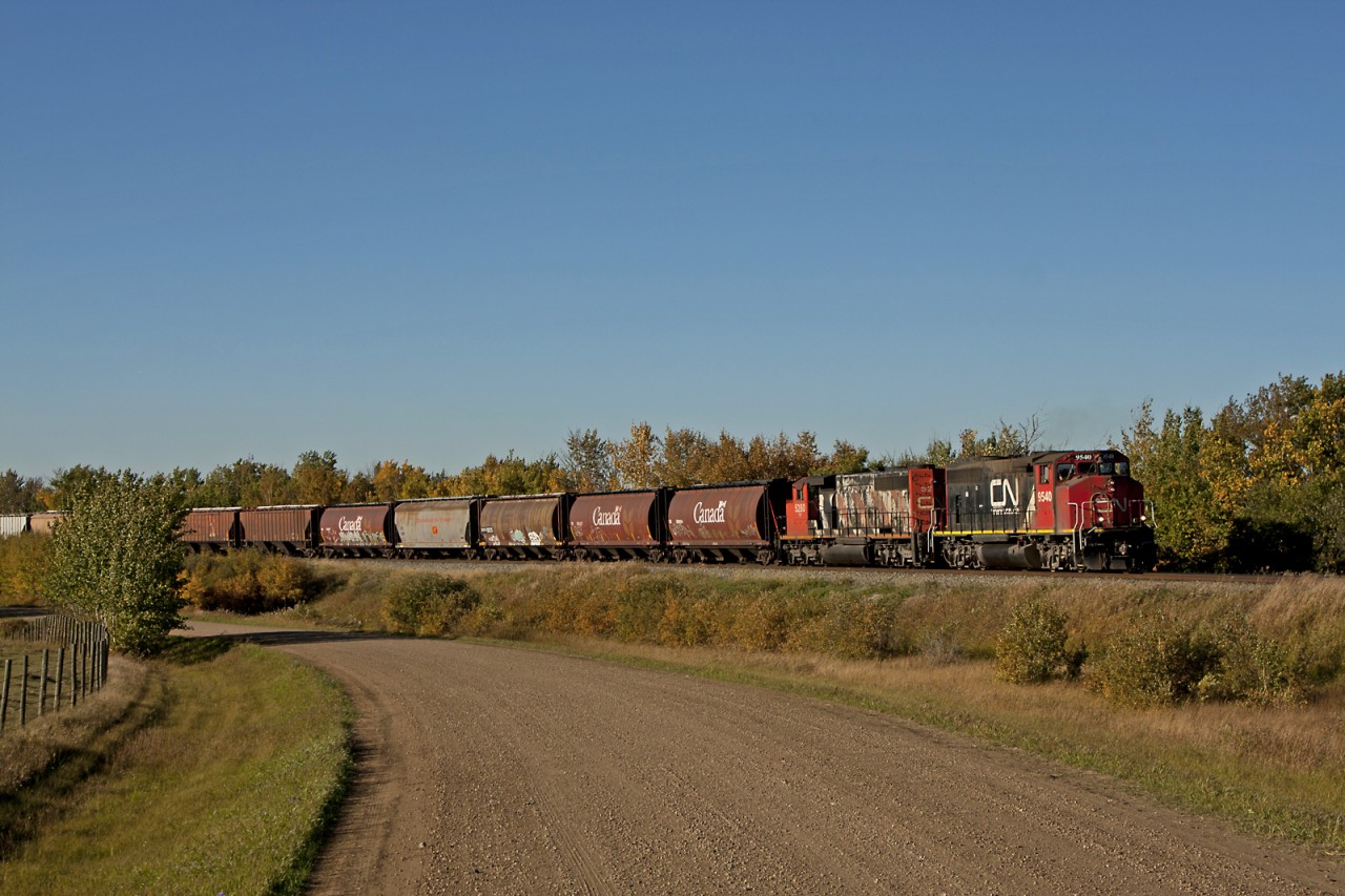Southbound Edmonton to Camrose train G810 acceleratesd up to speed after a meet with a north bound freight. Power today is a GP40-2LW and an SD40-2W