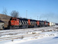 CN train 411 with four units on the head end - GP40-2LW's 9572, 9549, an M636 and another '40 - start the climb up the Niagara Escarpment at Limehouse, on CN's Guelph Subdivision.<br><br>The train is passing by a quaint sectionhouse(?), which appears to be made or clad in stone. The spur in the foreground is for Acton Limestone Quarries (later Indusmin), who operates a large limestone quarry here and was once an online shipper. <br><br> 411 was a regular Toronto-Sarnia train that was scheduled on the north route to London and on to Sarnia. It was always an interesting train.