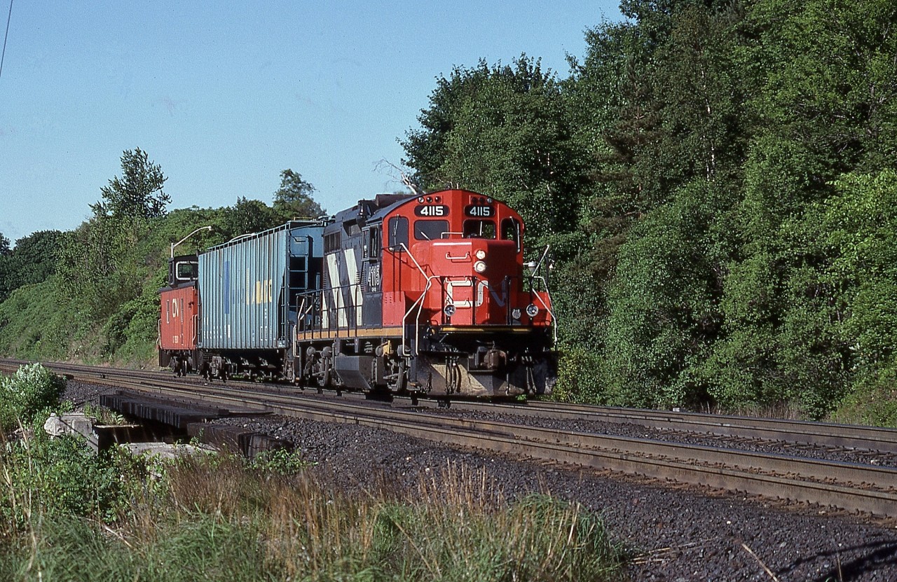 Canadian National GP9RM 4115 is shown eastbound approaching Bayview Jct. with a diminutive one car consist. Originally constructed by GMD in London, Ontario as light weight GP9 No. 4322 in 1959 with Flexicoil trucks and half sized fuel tank, she would carry her original number until being remanufactured by CN’s Pointe St. Charles facility in 1984. Having achieved ‘Freedom 55’ status the venerable unit is currently still active.