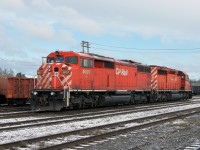 Surrounded by maintenance of way equipment and a dusting of snow, these units wait for duty on a brisk May morning in CP's yard at White River.