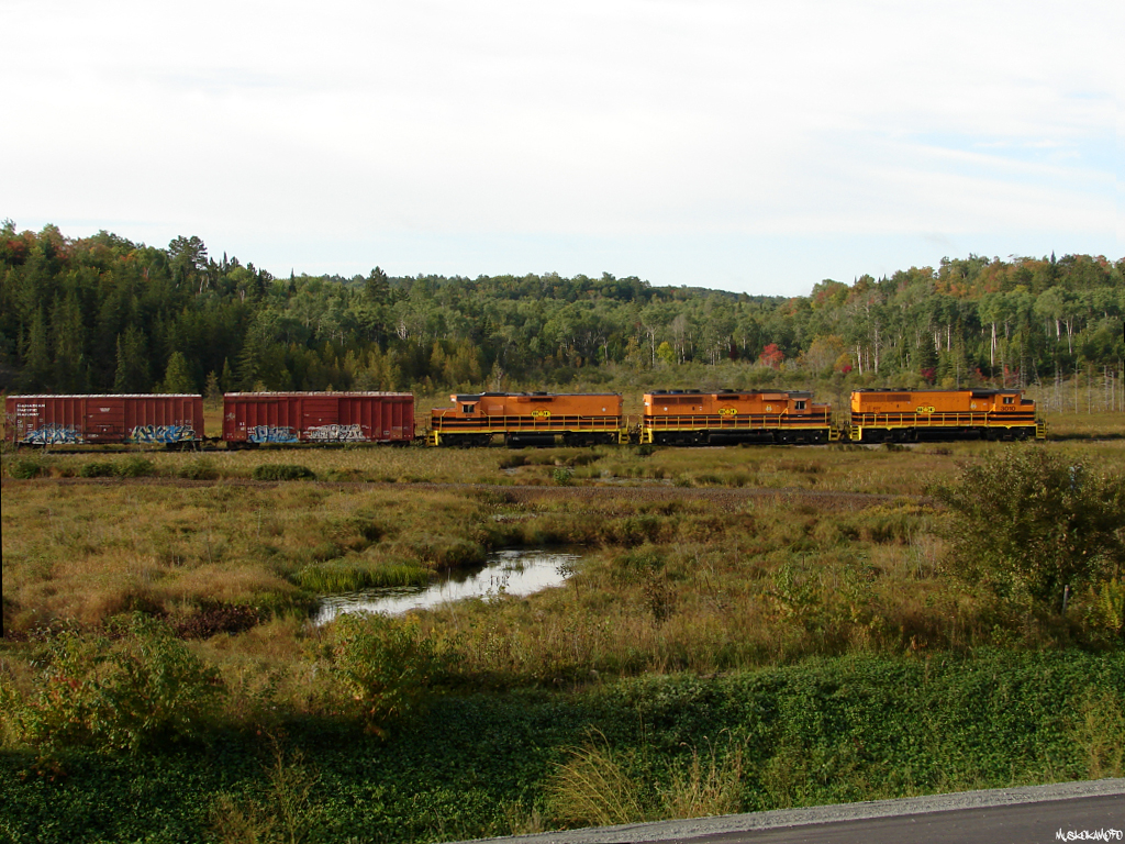 HCRY 911 - HCRY 3010 West trundles along the former CP now Huron Central Webbwood sub past the old Victoria Mine lead on a beautiful September morning.