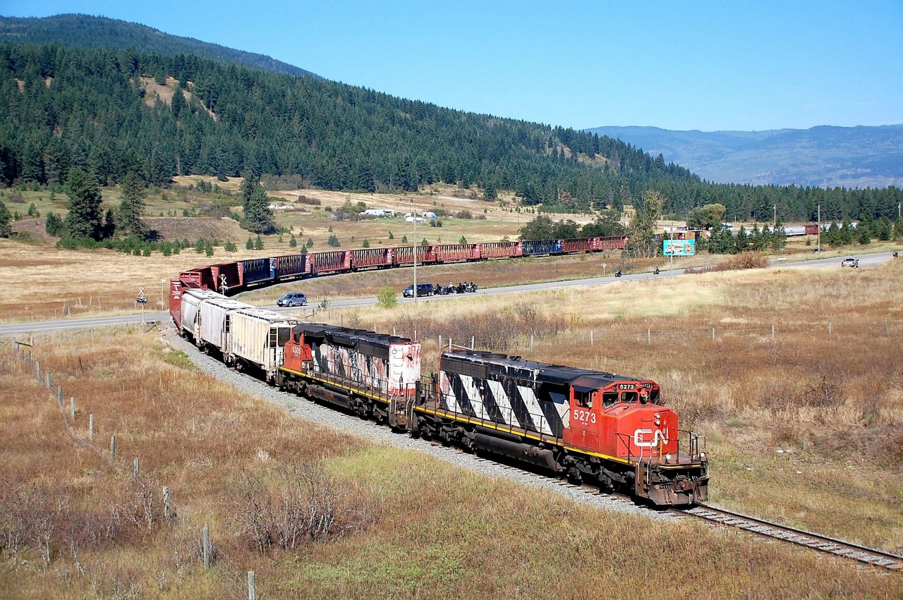 Crossing Hwy97 near O'Keefe..there are quite a few hoppers on the train today.