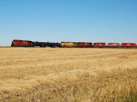 CP 672 meets CP 616. CP 672 with a nice variety of power waits for CP 616's rear DPU to clear to be able to head west towards Saskatoon after spotting its entire 140 car train at the Colonsay Potash mine. 