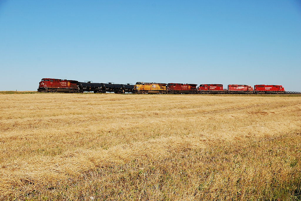 CP 672 meets CP 616. CP 672 with a nice variety of power waits for CP 616's rear DPU to clear to be able to head west towards Saskatoon after spotting its entire 140 car train at the Colonsay Potash mine.