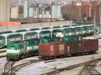 Anyone care for a slightly used EMD F59PH? <br><br> The new MP40's had begun to cut into the F59 numbers in a significant way, and a visit to Mimico found over a dozen GO Transit F59PH locomotives out of work and parked in the Willowbrook Yard deadlines. Units visible here are 520, 535, 531, 523 in one group, and 532, 528, 526, 530, 540 in the next. The obvious combo breaker here is 532, which is facing west when all GO's locomotives at the time ran on the east end of trains facing east (see the two trains in the background). It was used as a shop switcher before being retired, since GO usually turned a unit when they needed it for that duty. <br><br> While there's nine here, seven others sit in another group behind us to the west (GO 555, 527, 525, 521, 524, 533). Ironically enough, one of the trains in the background ready to head to Union Station sports a still-active F59 of its own. <br><br> Even more interesting are the three platform clearance test cars that were pulled out of their usual hiding spot on a nearby spur and spotted right in the yard. The first two are former CN 40' boxes, the last a former CP plug-door insulated-heated 40' boxcar, all with solid/friction bearing trucks and crudely renumbered GOOX 1, 2 & 3. <br><br> <i>For the roster keepers:</i> While units 540 and 555 would go back into service for another year or two, the other units (all of which came from the first GO order 520-535, class GCE-430g, built in Jul-Sep 1988 - making them nearly 21 years old) were sold off in the coming months as follows:<br> <br> March 2009: 520, 523, 531, 535 to RB Leasing (Quebec)<br> March 2009: 526, 530, 532 to MMA/Railworld (Maine) for rebuilding for SLC (AMT lease in QC)<br> April 2009: 521, 522, 524, 529, 533, 534 to RB Leasing (Quebec)<br> May 2009: 525, 527, 528 to Trinity Railway Express (Dallas, TX)