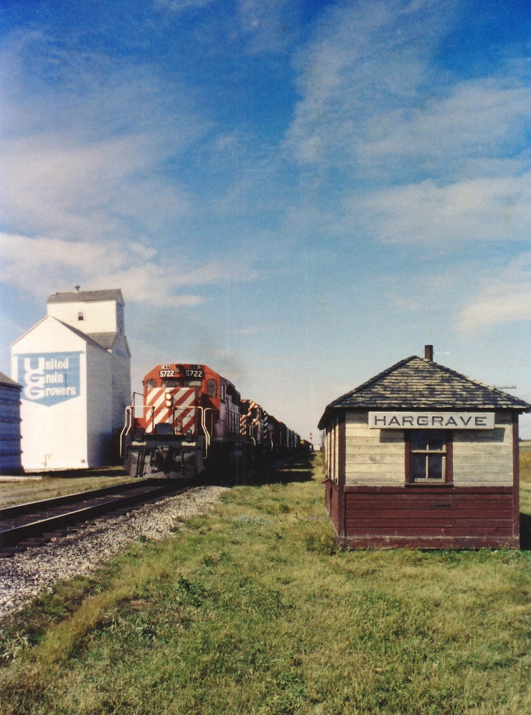 It was a race to photograph a prairie train that I almost lost. For I wanted to be on the sunny side of the tracks, but prairie trains run at such a speed thru the vast open lands that I had to be happy with what I could get. Not much to this little community, which makes me think the Namesign is on the original station, or, at least, if there was another station it would have been a grandiose monstrosity of the 1800s and replacing it with anything other than this practical little structure would have been wasteful. I love the paint and I sure wanted the sign. And wonder now if the building has been preserved, for it has been 38 years next week since I managed to catch CP 5722, 5549 and 5520 'flying' eastward on a beautiful late summer morning........