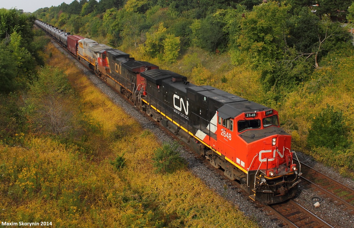 After getting a timely heads up that Canadian National oil train U71091 has just passed Georgetown, and a friendly note aside from that that they'll be making a crew change at Goreway, I head out to mile 22 of the York subdivision in hopes of getting it. It has CERX 1337 trailing, and this is the first CERX unit I've ever got before. Just as I arrive, I fire up my scanner and immediately I hear CN 2648 East, CN U71091 talking to foreman John Lino to obtain clearance from mile 19-18 of the York subdivision, which he's working on. Seconds later, U71091 gets its light and after a short wait, is seen in this picture passing through.