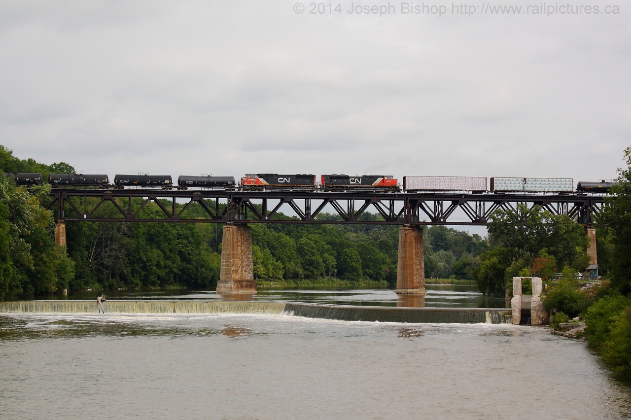 CN train 360 makes its way across the Grand River in Paris Ontario with CN 5750 and CN 8879 providing the mid train assistance.  On the point was CN 8020 and CN 5603.
