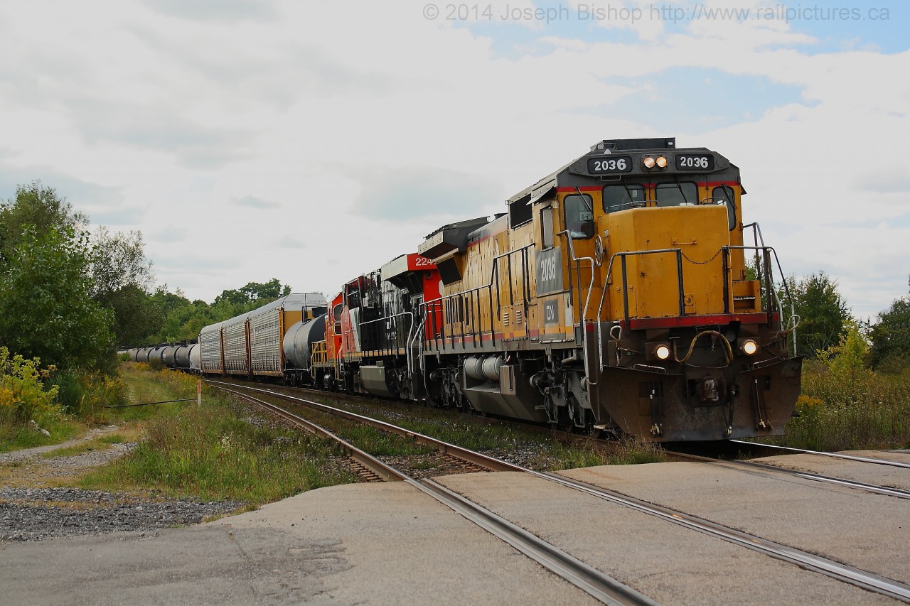 CN 2036 still in its Union Pacific paint leads train 332 by Powerline Road just outside of Brantford on a nice September afternoon.  Trailing 2036 is CN 2246 and NREX 410.  The SW is destined to ArcelorMittal Dofasco in Hamilton.