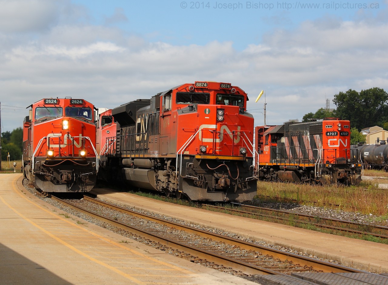 Triple Play At Brantford   CN 148 is seen passing CN 384 on the South Track at Brantford on a sunny September afternoon.  384's crew had run out of hours and received a crew change at Brantford.  384 would depart shortly after 148 cleared Massey's to make way for four westbound trains all between Lynden and Aldershot.