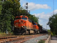 BNSF 5976 and BNSF 6421 lead CN U711 under signal 227N in Brantford with 100 empty tank cars heading back to be refilled.  