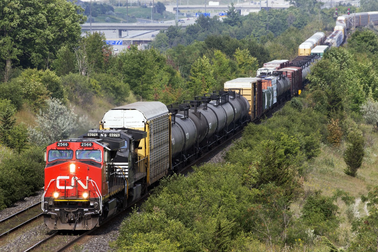 While I was waiting at the alley today, a short train heading east was waiting at the switch for a westbound train. It came but it wasn't any ordinary train. It had a Norfolk Southern unit lashed up pulling a mixed train.
