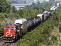 While I was waiting at the alley today, a short train heading east was waiting at the switch for a westbound train. It came but it wasn't any ordinary train. It had a Norfolk Southern unit lashed up pulling a mixed train.