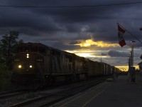 While I thought the possibility of catching CN 330 in a wicked sunset was over with the shortening days, this easily has to be the most interesting lighting I've ever received with a picture of a train in it. With heavy cloud cover, small slivers of sunlight reach through. While it may appear the sun is peering through the clouds, the sun is actually far off to the right of this picture, just a few minutes from dipping below the horizon. Here, CN 330 passes St. Catharines with a zebra GE cowl leader. Hearing the distinctive whine of an ES44AC, I was expecting it to be a CN, however the lashups from Sarnia never fail to surprise. After crawling all the way from Grimsby, the Welland Canal bridge was finally put down, and 330 throttled up coming out of the Jordan dip. Even though this train is less than 50 cars long, CN 2410 and BNSF 5837 are really putting in effort to get up to speed, evident by the heat distortion which is blurring the sunlight above the ES44AC. 
