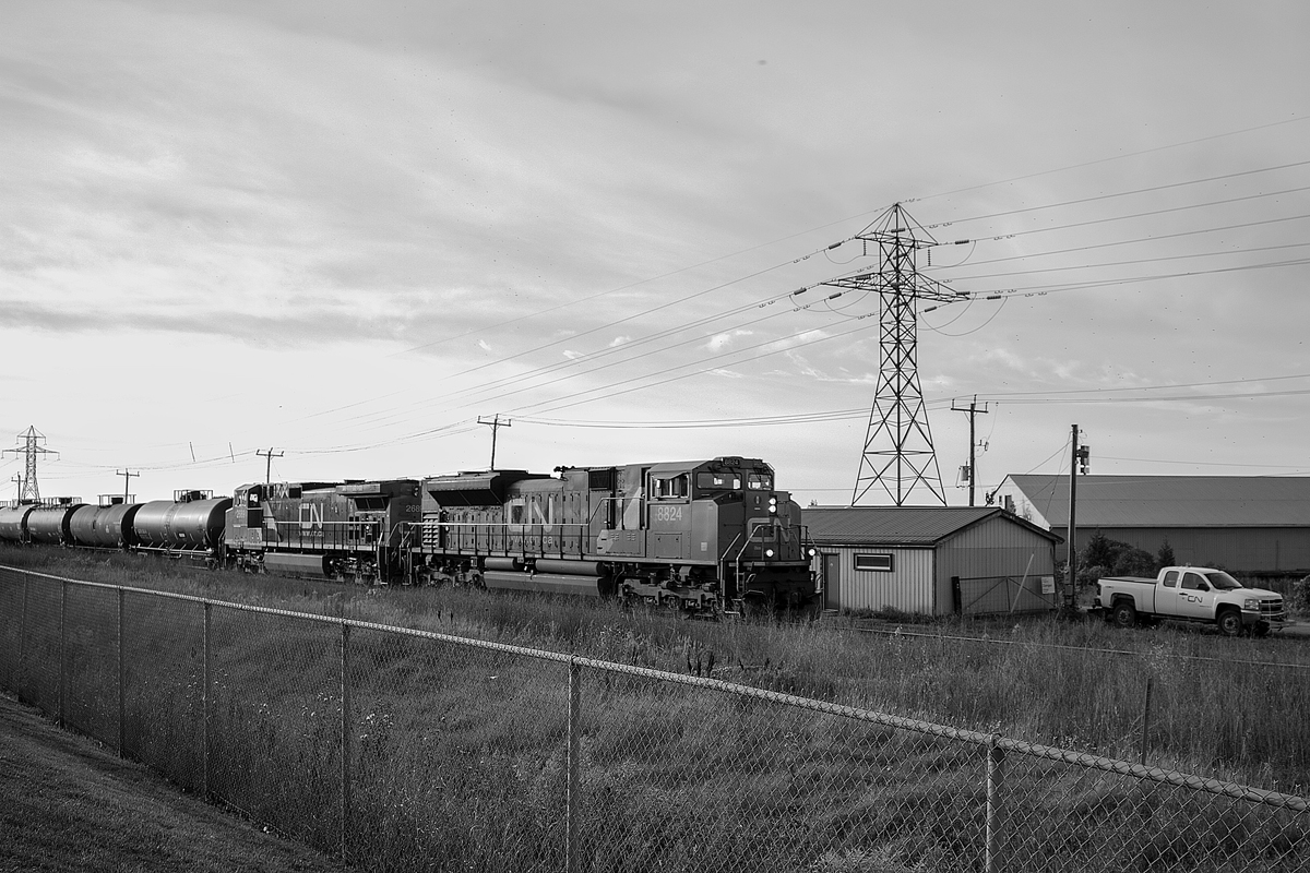 After making my weekly return trip down from Barrie, I noticed CN 330 passing through Stoney Creek. While I wasn't all too happy it was just a pair of CN locomotives, an SD70M-2 leader is something I'll stop for. Trying something different for once, here it is with CN 8824, 2669 and a short manifest passing through Beamsville. In front of the CN shack is a foreman ready to eye for any defects with the train. In less than five miles, a more technologically advanced scan will be done by a hotbox detector. This location holds many memories for me, as I used to railfan here frequently in my puny days, except I always stayed where the CN shack was. However, since then, security has heightened significantly, and my age is high enough now to receive a good scowl from any CN employee bitter towards railfans.