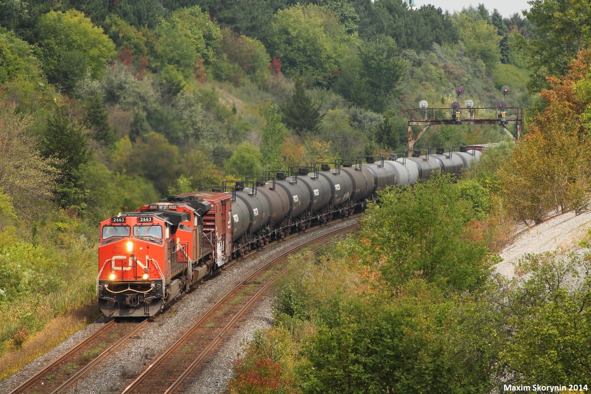 CN 305 cruises by Hilda just as the sun pops out from in between the clouds with GE DASH 9-44CW 2663 in the lead.