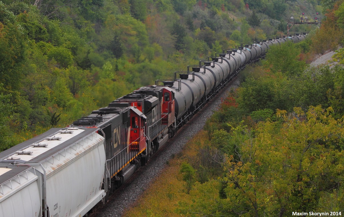 On the first day of September 2014 with school starting tomorrow, detour train CN 360 is seen here passing through Hilda with the sun hiding behind the clouds, and double DPU's! Recently, 360 has been going through Toronto almost every day and almost always has double DPU's, usually being Norfolk Southern units. Speaking of NS units, I was hoping for some on this train, but oh well! This does for a first timer.