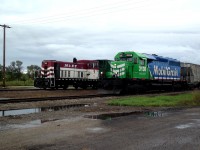 Chamberlain assigned switcher, GE 70 Tonner 604, is returning to the siding after pushing 3 loaded grain hoppers onto the main. MGLX 3138 has connected to the loads and is heading east, towards Regina. 