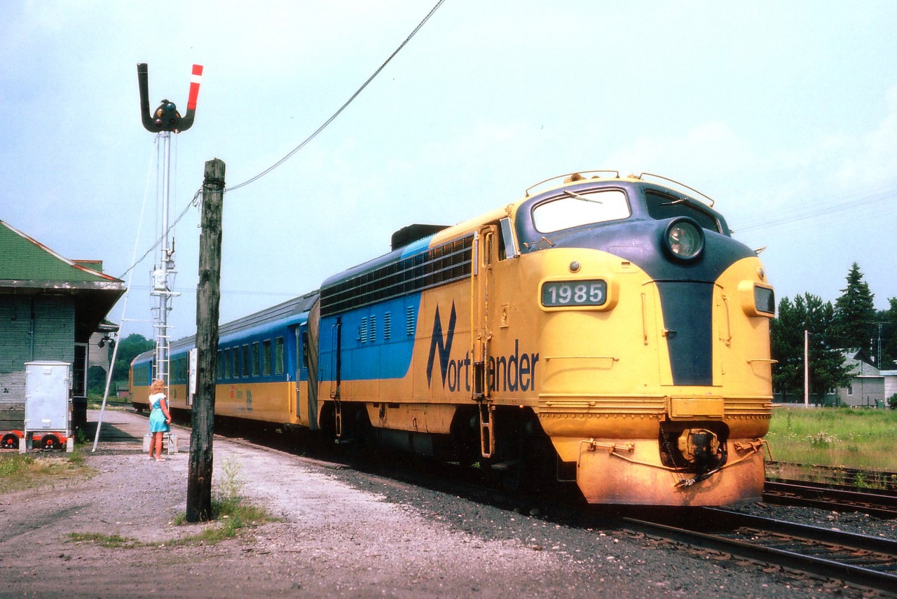 Southbound ONR Northlander shown here stopped at South River back in the days when there actually were more passengers along the line. Lead unit retired in 1993 and scrapped in 2000. In the last years of the service (train discontinued in 2012) the station was boarded up and VIA brought in a waiting room kiosk for any passengers. Of course vandals tried to make short work of both. Young lady in photo was sidekick of the photographer back then and its already been many years since she wizened up and moved on. :o)