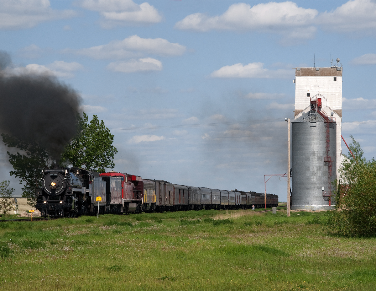 After a sod turning ceremony for a new intermodal terminal on Regina's western outskirts, Empress 2816 with CP executives including CEO Fred Green passes the Pense elevator on its way to Moose Jaw for servicing and an overnight stay before continuing to Calgary.