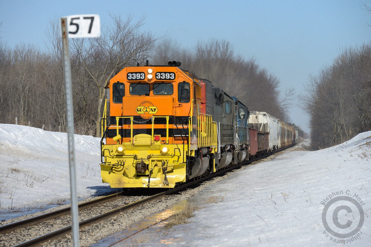 It's late March and while the right of way may be clear, the rest of the winter 2014 deluge still has a ways to go to completely melt. GEXR 431 is passing the Mile 57 marker on the Guelph S/D with clean 3393 leading the way in bright GW orange, in stark contrast to the typical winter colours.