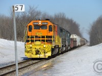It's late March and while the right of way may be clear, the rest of the winter 2014 deluge still has a ways to go to completely melt. GEXR 431 is passing the Mile 57 marker on the Guelph S/D with clean 3393 leading the way in bright GW orange, in stark contrast to the typical winter colours.