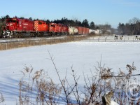 At Milburough line, a quartet of EMD(eecent) powered engines are growling as the tail end clears one of the two ruling westbound grades for the Galt sub. (The other westbound ruling grade is Orrs Lake hill, 25-30 miles to the west). Shot with 50mm f/1.8.