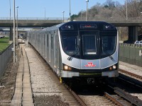 A shiny new stainless steel "Toronto Rocket", built in Thunder Bay by Bombardier, pulls into Eglinton West subway station on the Spadina line. While this one is heading southbound to downtown (and on to Finch), in the background another TR can be seen trailing northbound to Glencairn.