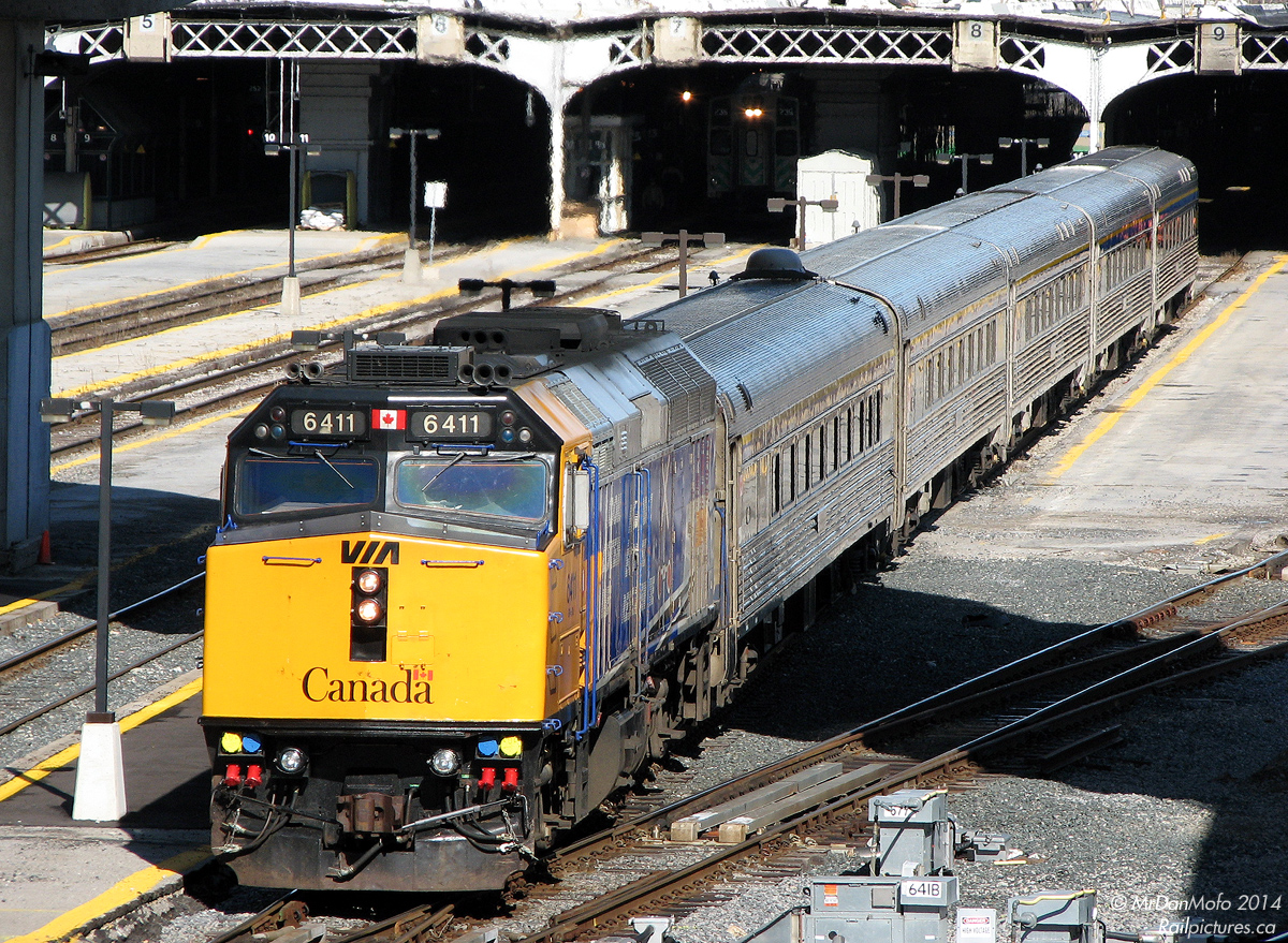 VIA "Operation Lifesaver" F40PH-2 6411 backs 83's train of five stainless steel Budd "HEP" cars into Union Station and under the train shed on Track 9. The shiny yellow nose was probably a recent development, as the unit previously had some OLS & sponsor logos on it.
The extra pair of horns at the front was the first application of this feature on VIA F40's, which would be fully adopted during the rebuild program. The front two horns are emergency horns, normal horn use is through the nearly invisible one in front of the first rooftop fan.