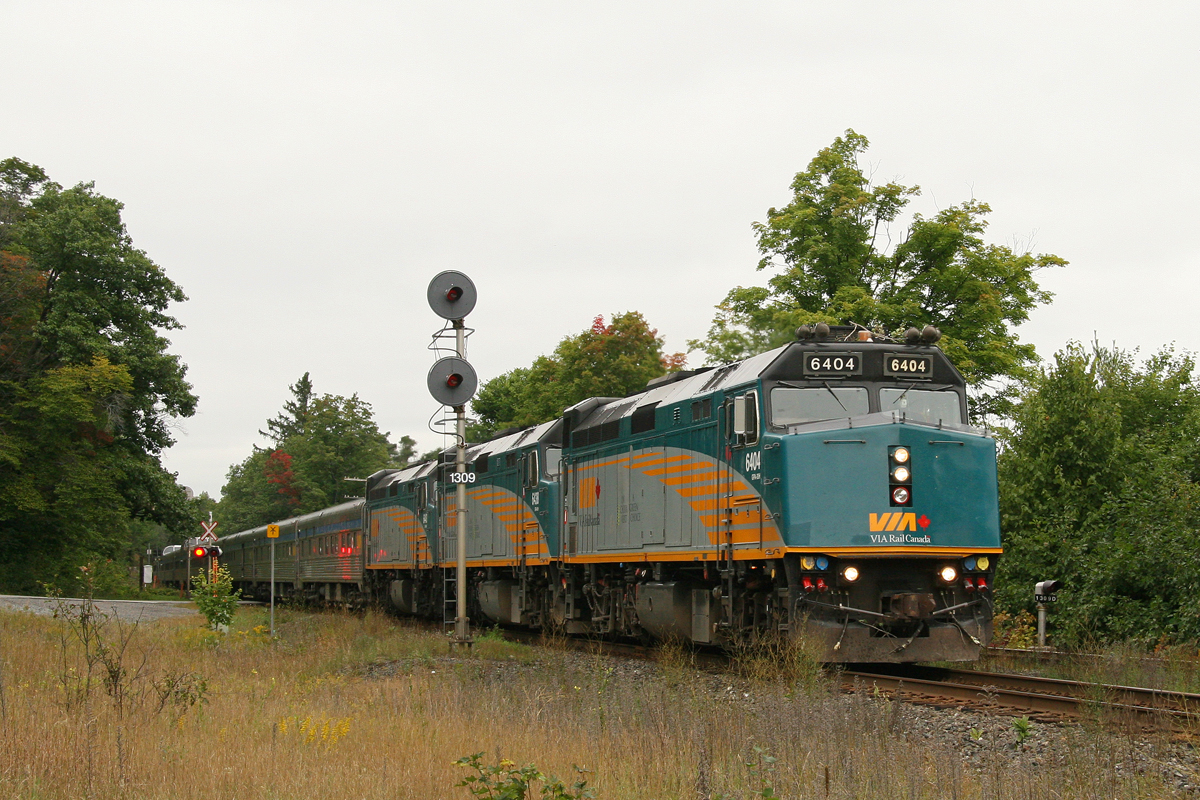 Was returning from an overnight trip to Parry Sound, ON, when we stopped near MacTier ON on a heavy overcast day for a southbound train.  We had expected it to be a freight but snapped a late running VIA #2 at Dock Siding N, MP 130.9, Bala Sub. seen at 13:14pm.