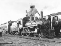 Here the 136 is spotted in a perfect rods-down pose has been turned and coupled to the rear two wooden coaches for a short runby at the bottom of the yard to recreate an old style consist. Looks like Bill Stewart is backing the 1057 in to place to spot it under the chute to coal up. That tank-like structure set on an angle was a modern style small coal tower. It replaced an old wooden structure. <br> <br> 
That mark on the bottom of 136’s smokebox was created from being melted by the burned hot cinders that piled up against it. This plugging up was a common thing on light engines but was this was severe and had already been shoveled out in a huge pile at Inglewood when we stopped to take water and stage a short runby.  Water had already been taken at Streetsville and would again be taken at Cataract this being all four places on the Orangeville Subdivision that had water tanks.  <br> <br>

Raymond L. Kennedy
